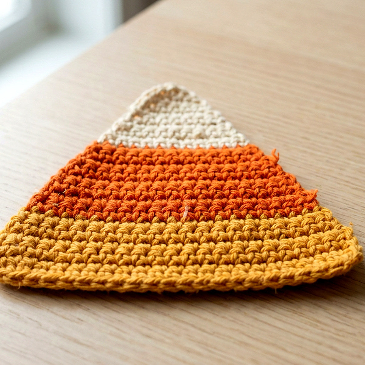 Candy Corn Coaster — the finished object this pattern is designed to produce